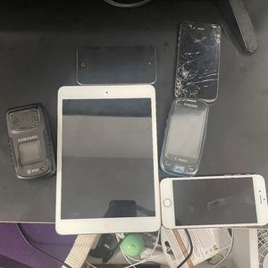 An IPhone 7 an iPad mini 1 iPhone 4S an Samsung Sgh A837 Rugby 2 and Sgh T749